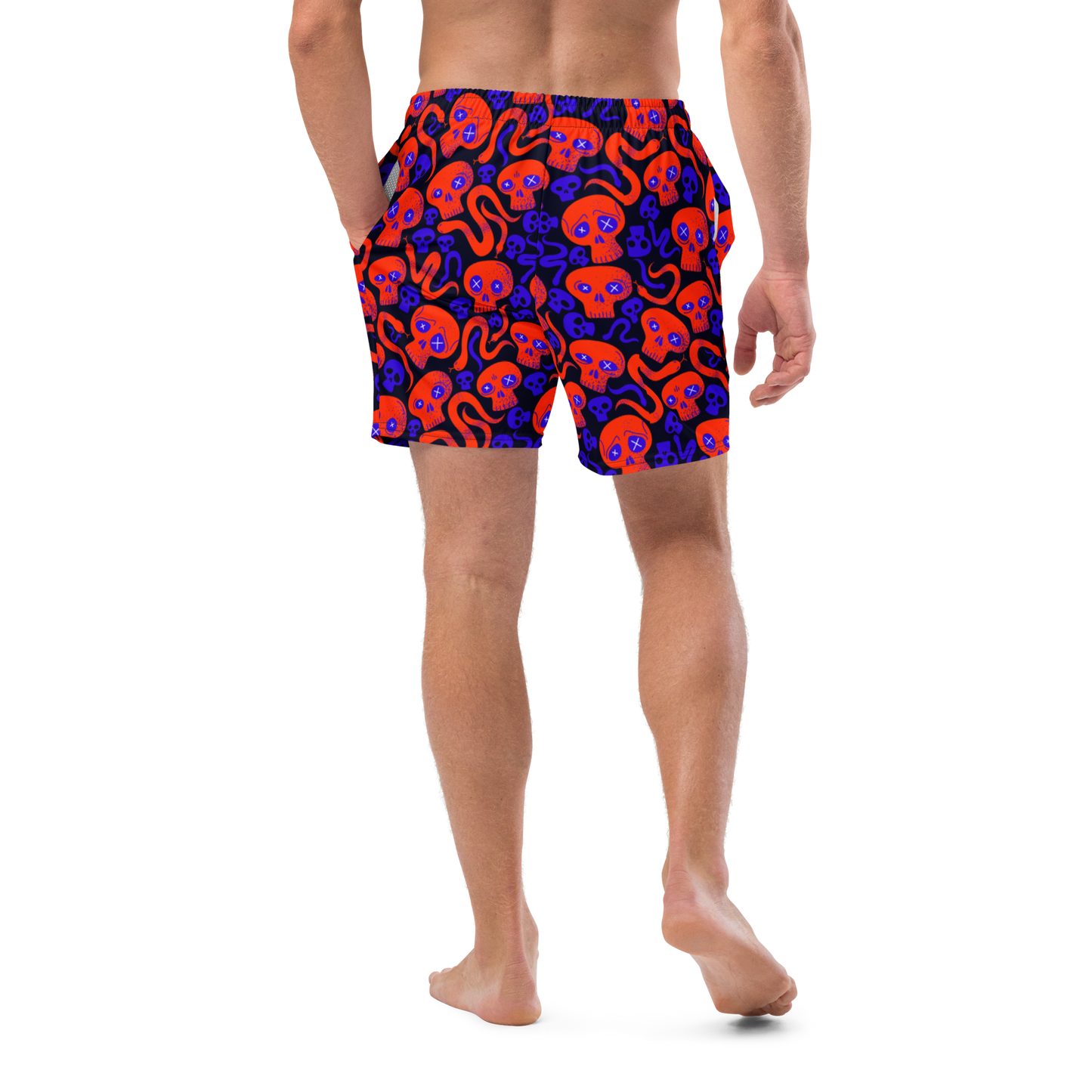 Person wearing colorful Halloween-patterned organic swim trunks on a transparent background