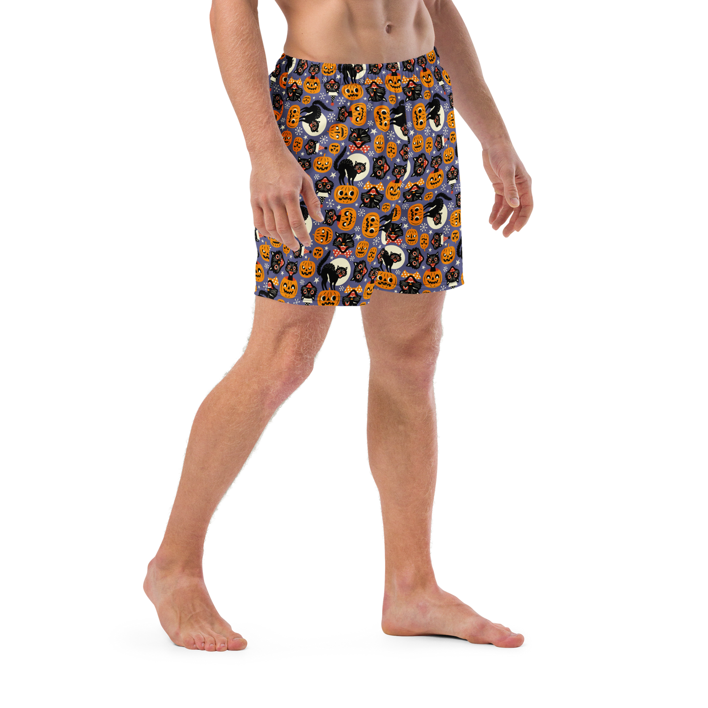 Person wearing Halloween-themed recycled swim trunks on a white background