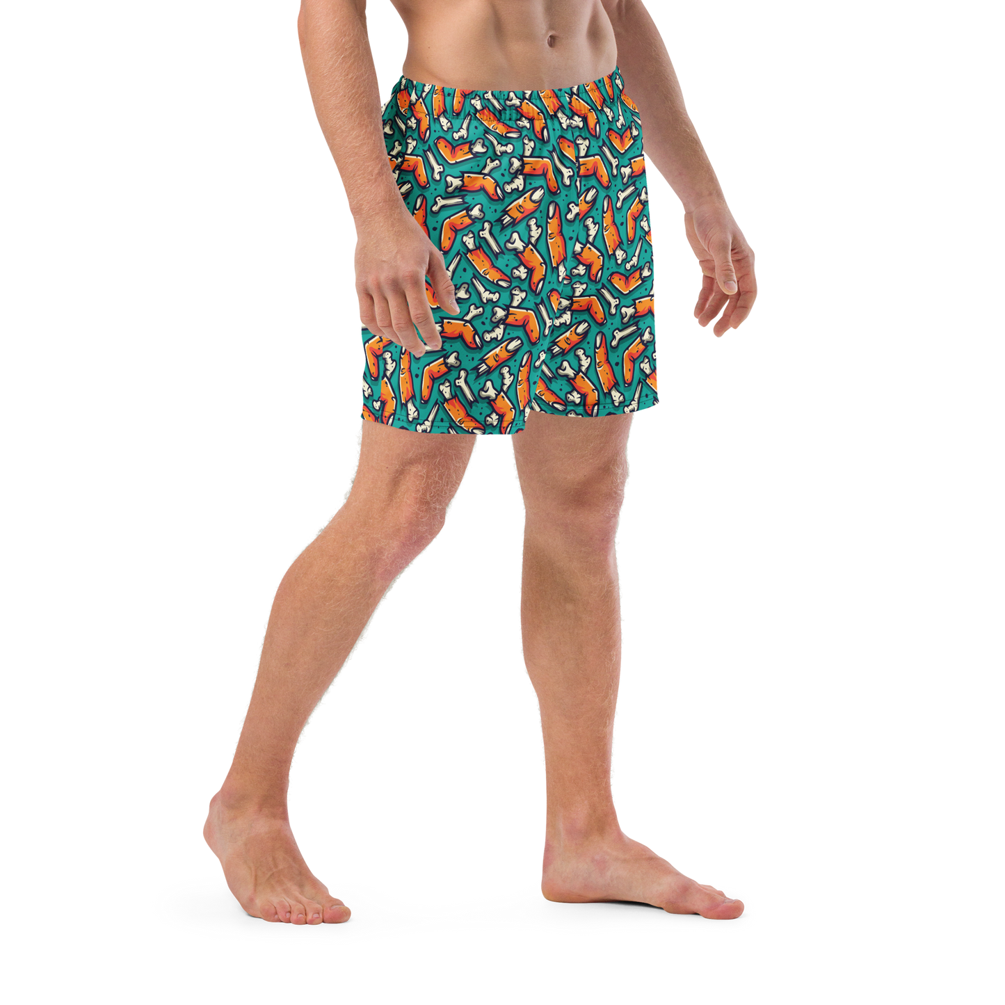Person wearing colorful Halloween themed organic swim trunks with a zombie fingers pattern on a transparent background