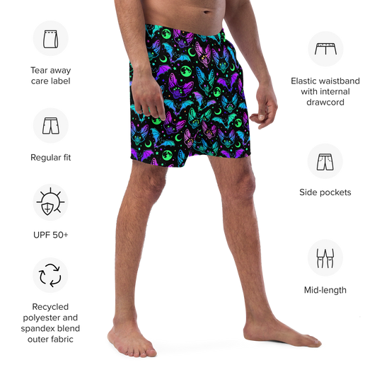 A person wearing Halloween themed organic swim trunks with product features listed on a white background