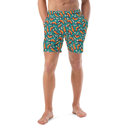 Person wearing colorful Halloween organic swim trunks with a zombie fingers pattern on a transparent background