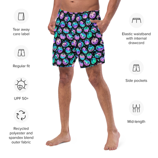 Person wearing colorful Halloween-themed organic swim trunks with product features listed on a white background.