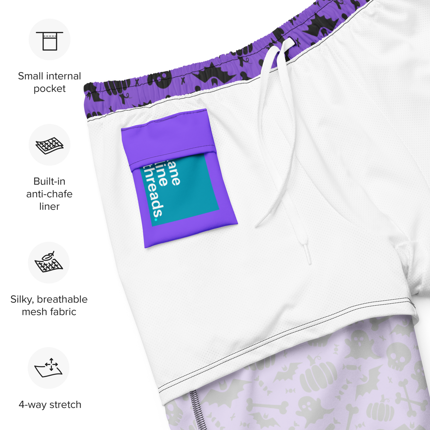 Halloween organic swim trunks with purple accents and a built-in anti-chafe liner, featuring Lane Line Threads brand label on a white background