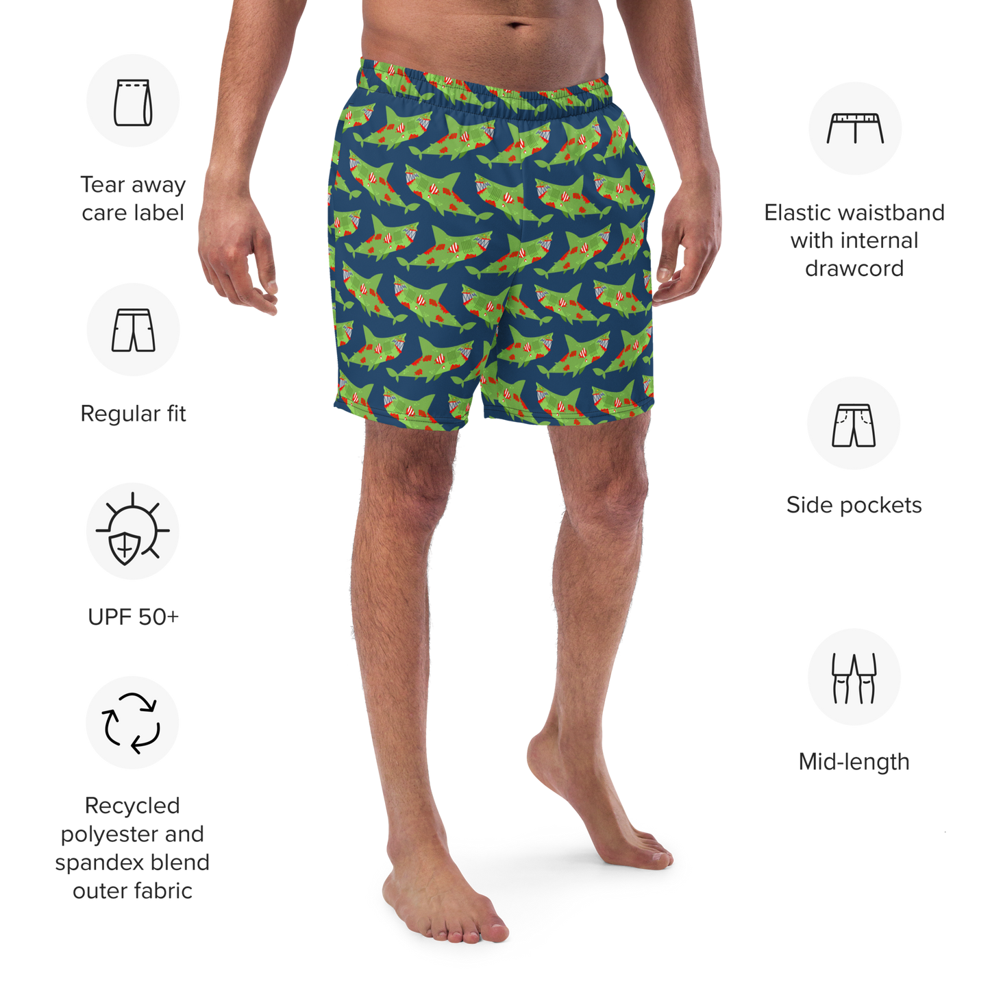 Person wearing shark-patterned Halloween organic swim trunks with product features listed on a white background