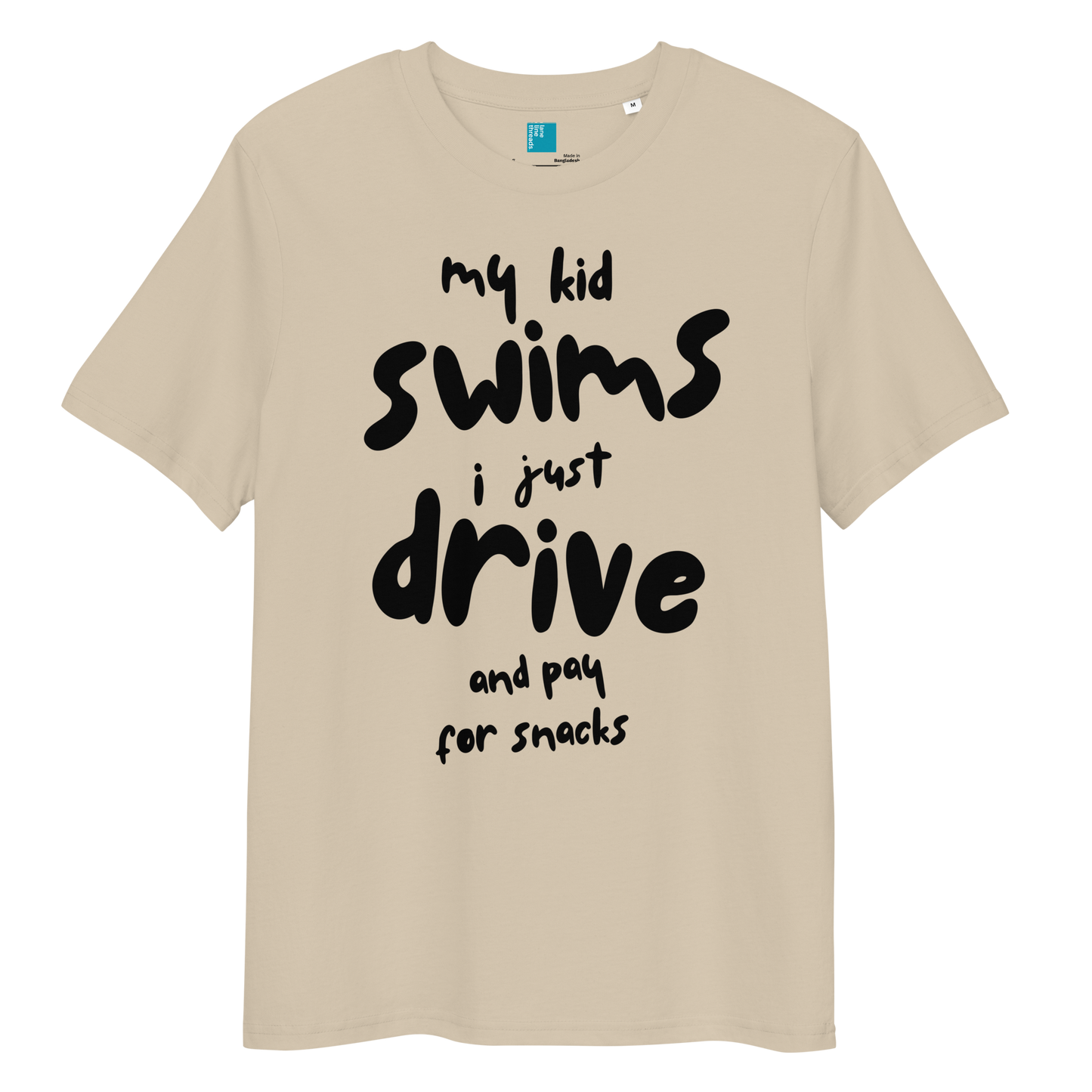 Desert dust organic cotton t-shirt with bold black playful text: “my kid swim, i just drive and pay for snacks,” perfect for swim moms with a sense of humor.