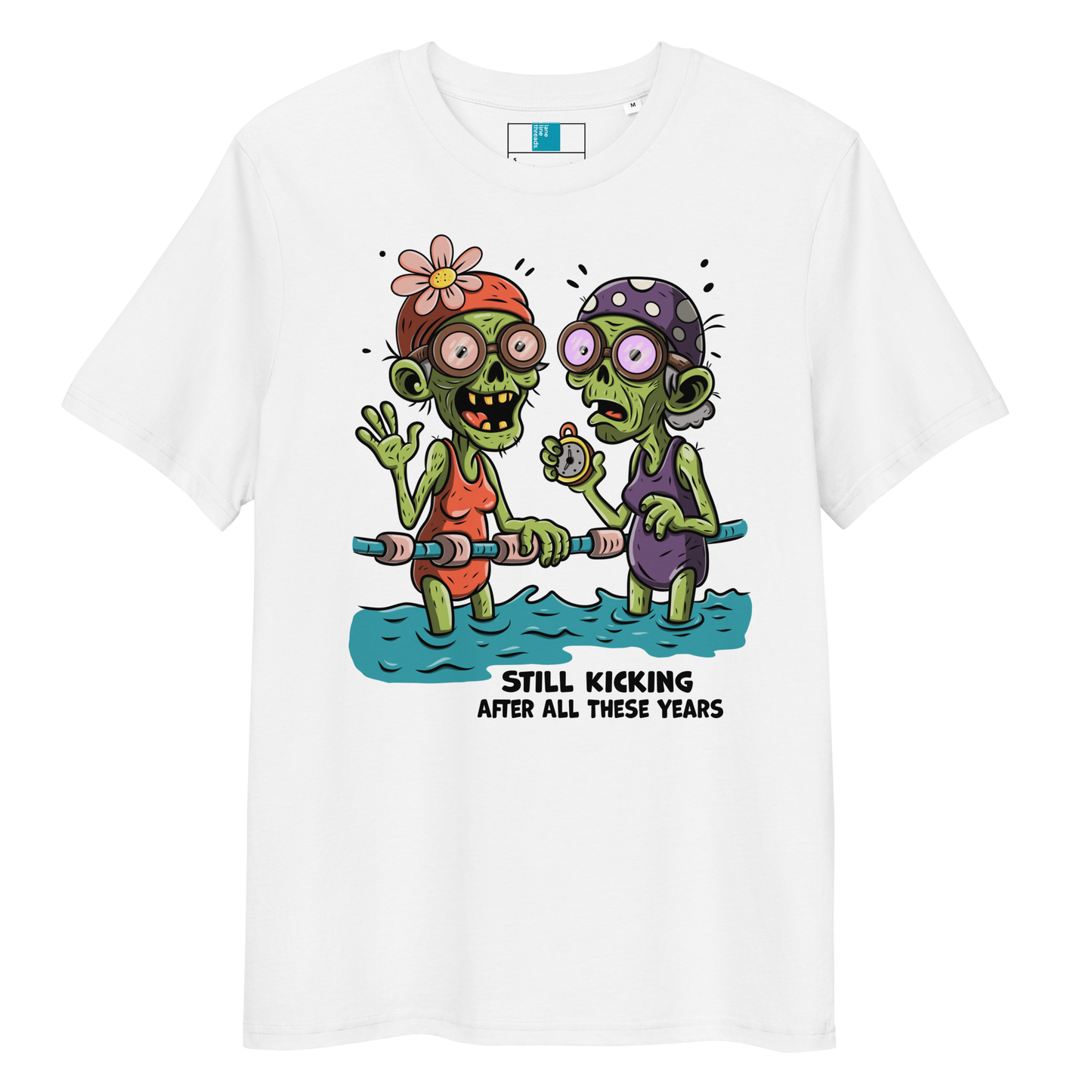 White organic cotton Halloween swim practice shirt with cartoon zombie swim besties holding lane line, text reads ‘still kicking after all these years'