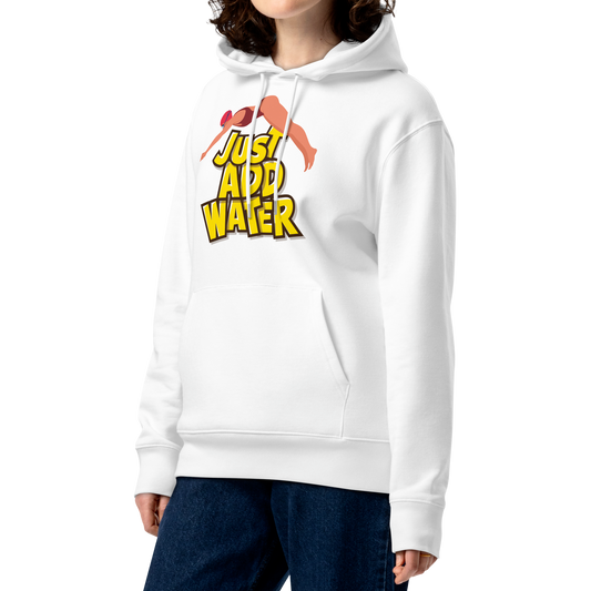 A woman with curly brown hair wearing an organic hoodie in white by Lane Line Threads with a “Just Add Water” swim graphic and female swimmer illustration, made from GOTS and OCS certified organic cotton.