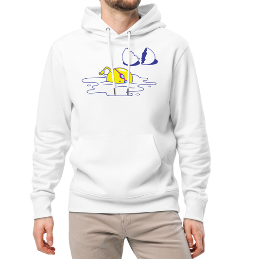 A man modeling an organic hoodie in white by Lane Line Threads featuring a graphic of a swimming yellow egg yolk with goggles and a cracked shell, paired with beige pants and white sneakers, against a plain white background.
