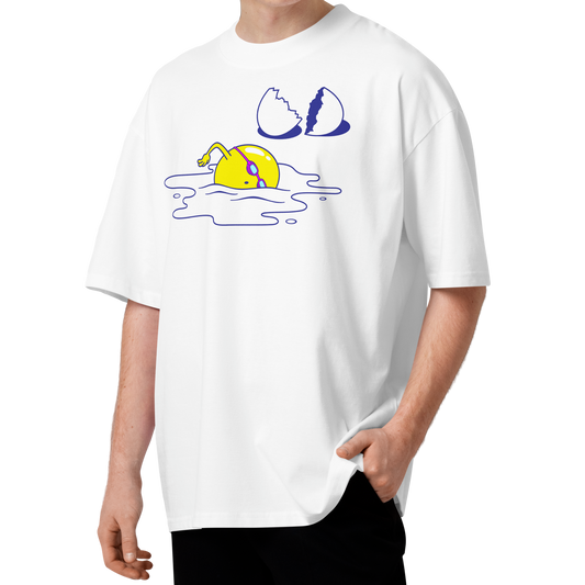 A young man with curly brown hair wearing a white short-sleeve crewneck organic oversized t-shirt by Lane Line Threads featuring a graphic print of a yellow cartoon egg yolk swimmer character breaking an egg on a white background.