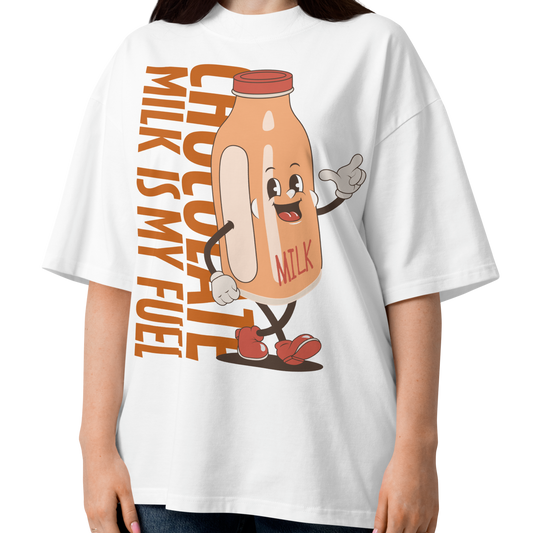 A woman wearing a white short-sleeve crewneck organic oversized t-shirt by Lane Line Threads featuring a cartoon graphic of a vintage milk bottle character with the text 'CHOCOLATE MILK IS MY FUEL' printed vertically in orange and inspired by Katie Ledecky.