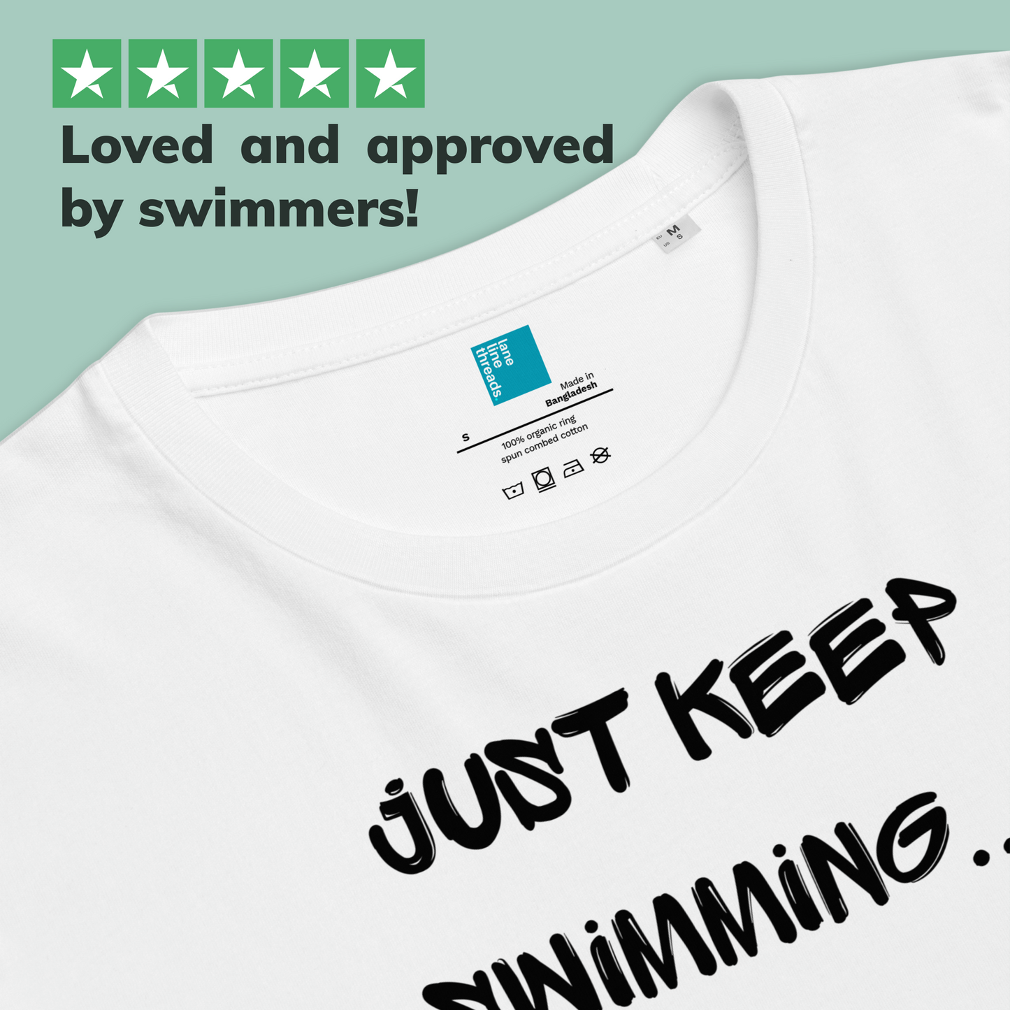 White organic post swim shirt with 'JUST KEEP SWIMMING...' text and Lane Line Threads brand label on a light green background