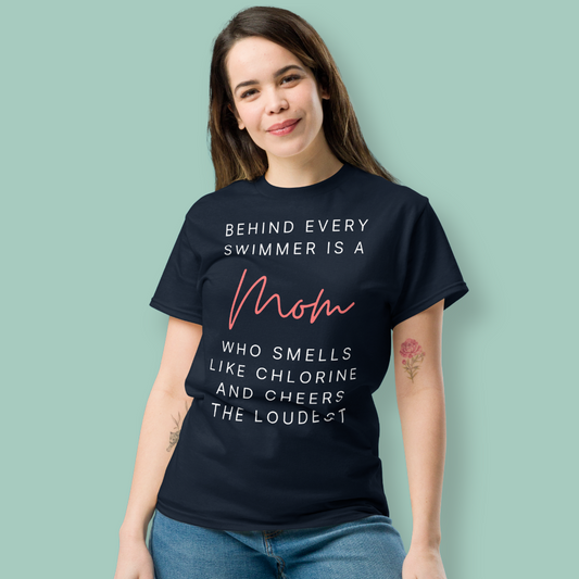 Person wearing a black organic swim mom shirt with a humorous quote about swimmers and moms on a light green background