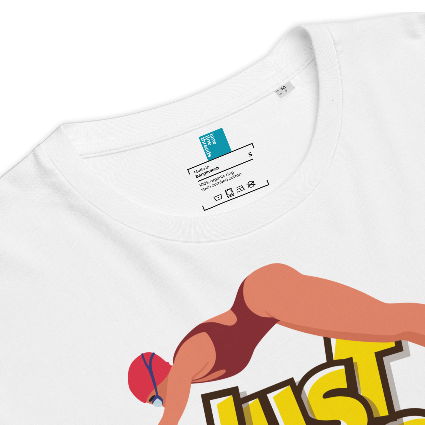 White organic swim shirt with a graphic of a woman in a swimsuit and 'JUST' text, close-up view.
