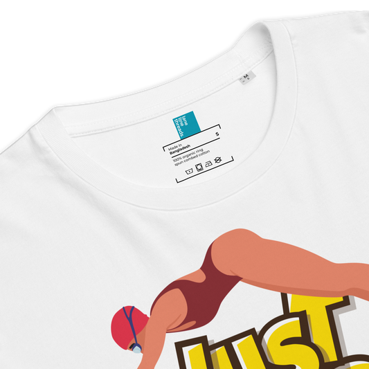White organic swim shirt with a graphic of a woman in a swimsuit and 'JUST' text, close-up view.