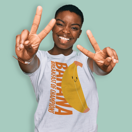Person wearing a post swim organic t-shirt with a banana graphic and text, making peace signs against a light green background