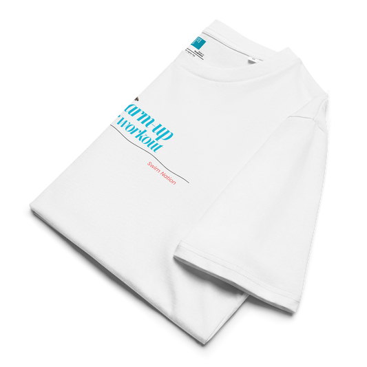 Folded white organic swim shirt with 'My Warm-Up Is Your Workout' slogan in vibrant blue and red text.