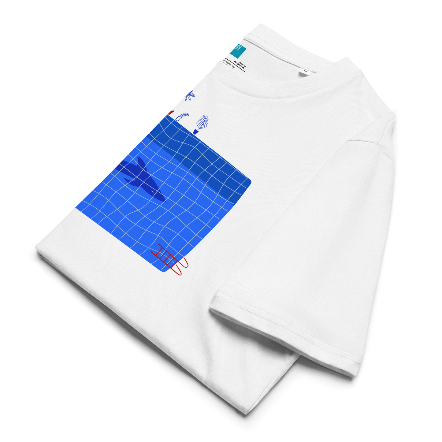 Folded white organic swim shirt with blue pool and shark illustration, eco-friendly shirt for swimmers, swim moms, and dads