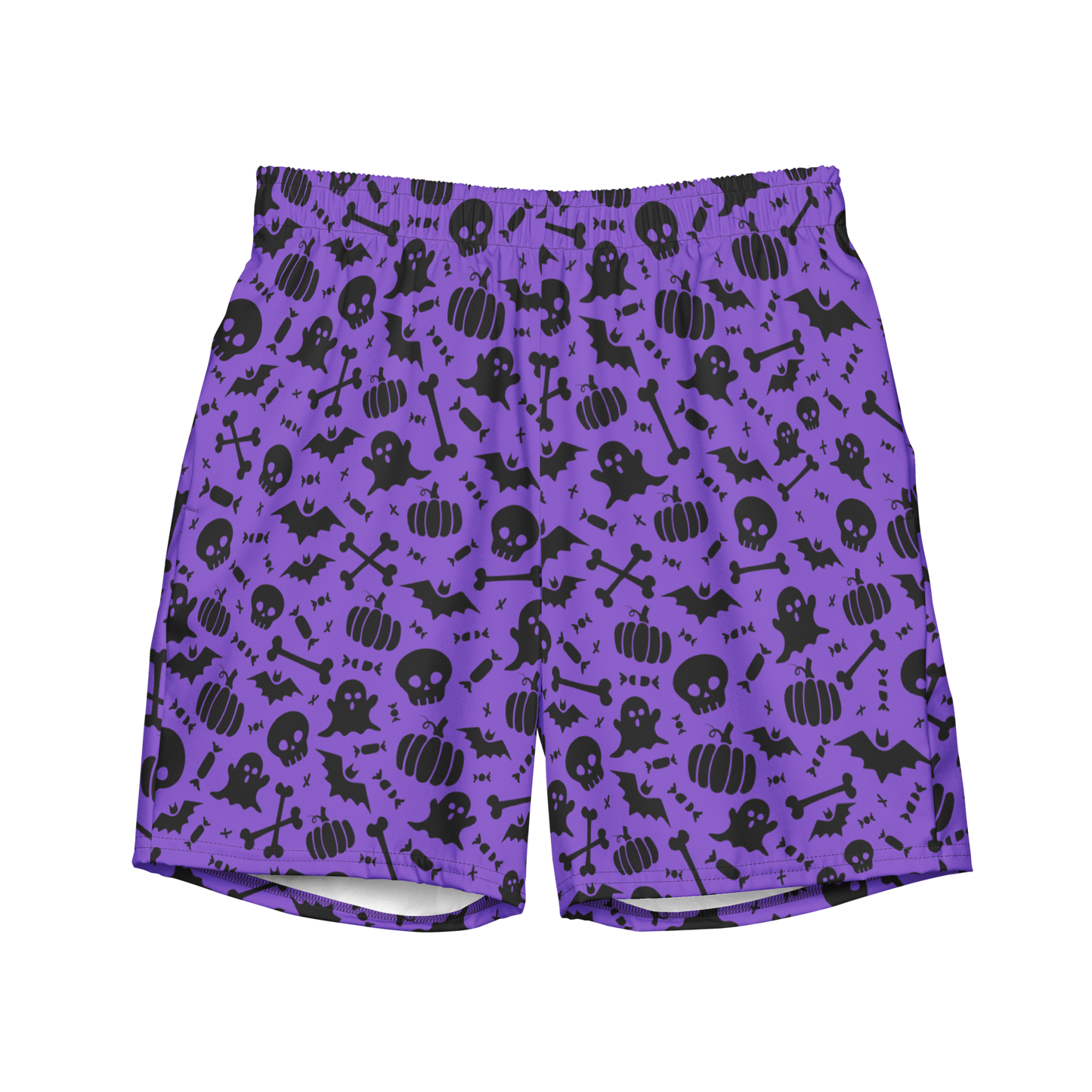 A pair of purple organic swim trunks with a repeating pattern of black Halloween-themed graphics including ghosts, pumpkins, skulls, bats, and bones.
