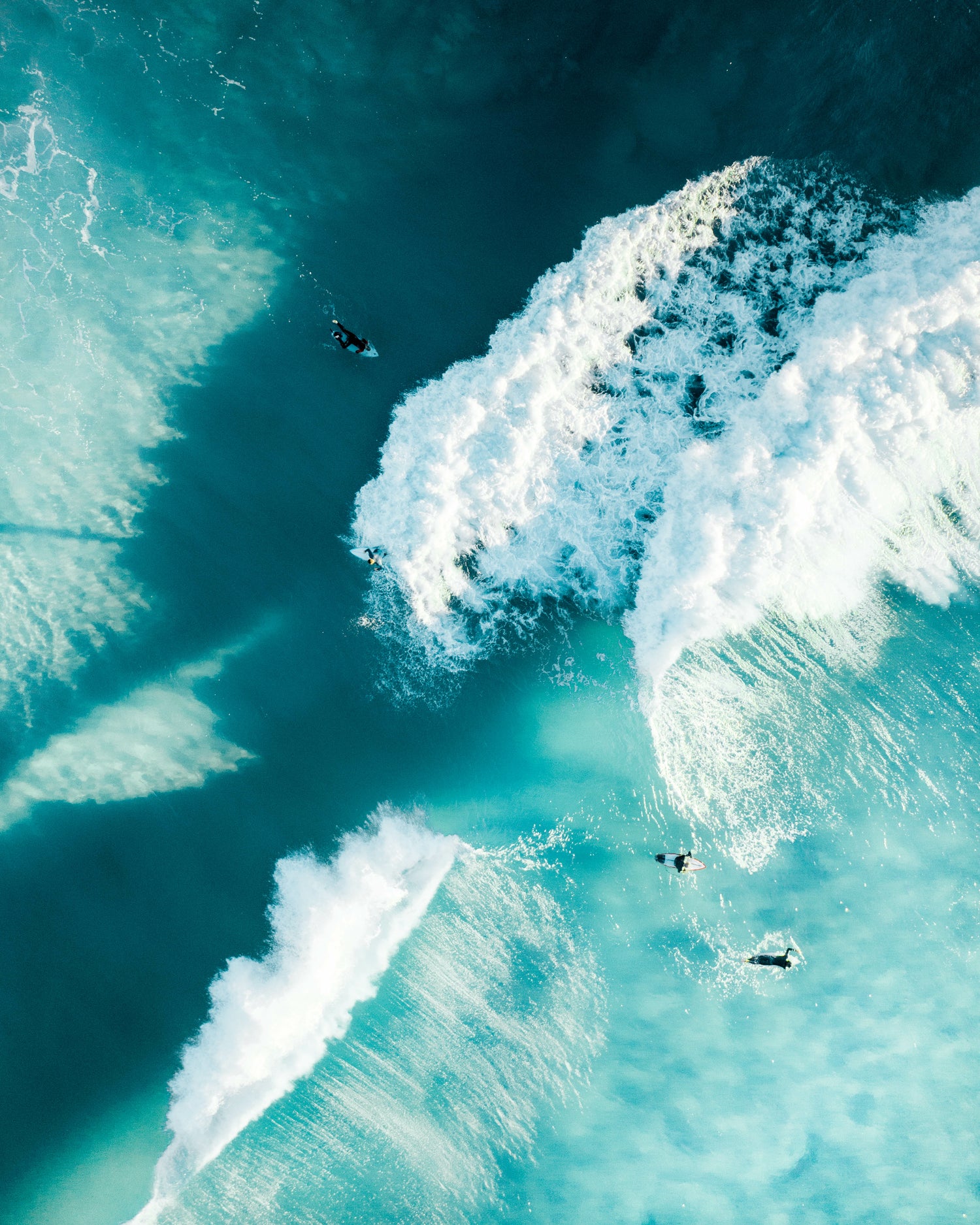 Surfers in the ocean with large waves