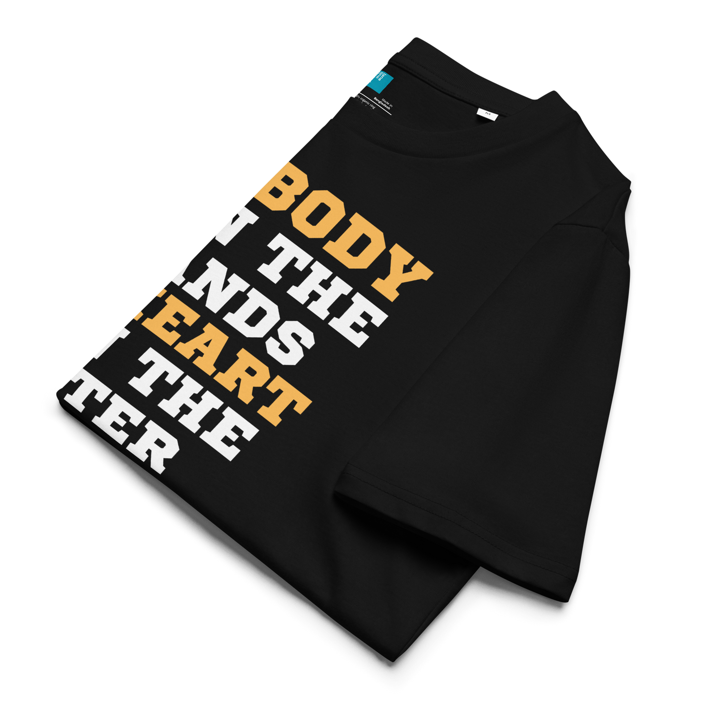Black organic cotton swim mom t-shirt with bold text: “My Body Is in the Stands, My Heart Is in the Water,” displayed on transparent background folded