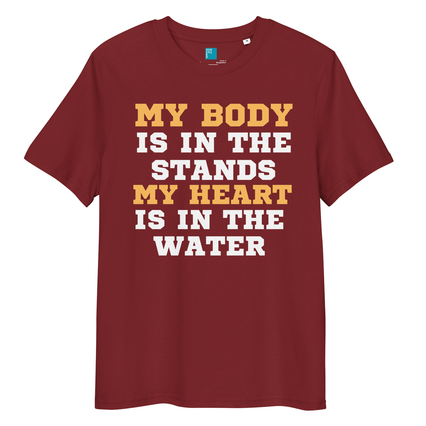 burgundy organic cotton swim mom t-shirt with bold text: “My Body Is in the Stands, My Heart Is in the Water,” displayed on transparent background