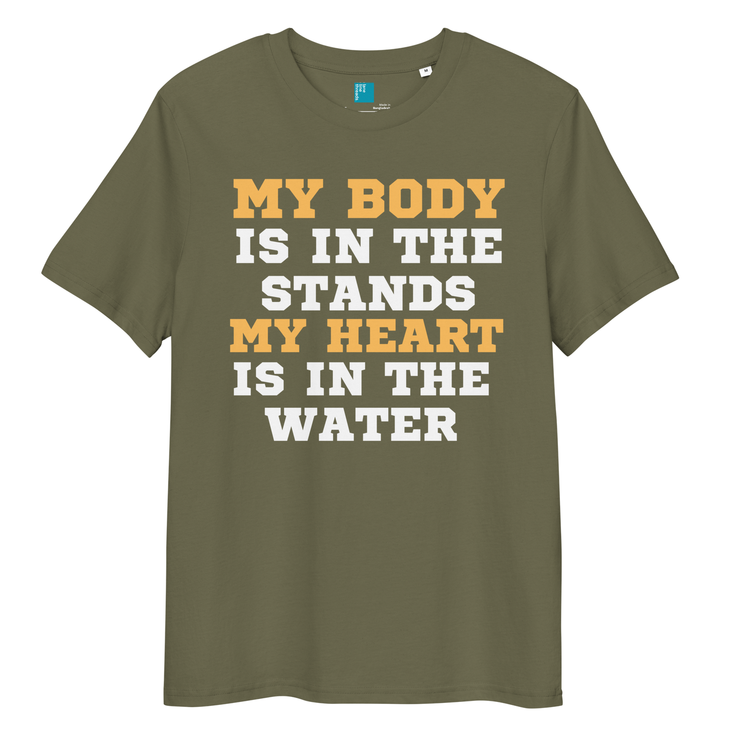 Khaki organic cotton swim mom t-shirt with bold text: “My Body Is in the Stands, My Heart Is in the Water,” displayed on transparent background