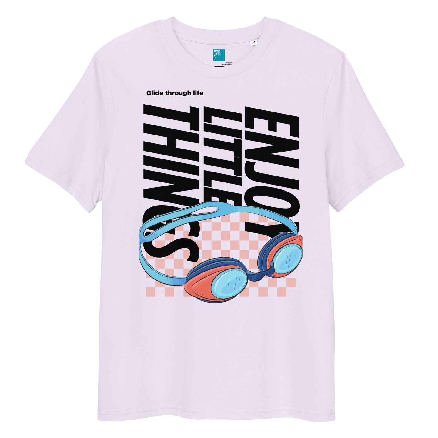 Lavender eco-friendly t-shirt featuring vibrant blue and red swimming goggles with a checkered background, and bold black text "ENJOY THE LITTLE THINGS" rotated vertically. Above the goggles, "Glide through life" is in smaller text. Made from 100% organic cotton, this breathable and biodegradable shirt is perfect for competitive swimmers who value comfort, performance, and sustainability. Ideal gift for swim meets or lane-protecting athletes with a sense of humor.