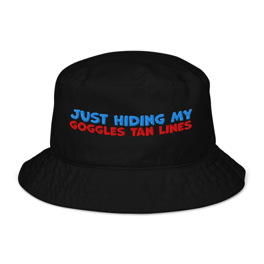 Black organic bucket hat with blue and red embroidery reading “Just Hiding My Goggles Tan Lines.” Eco-friendly, breathable, and biodegradable swimmer hat.