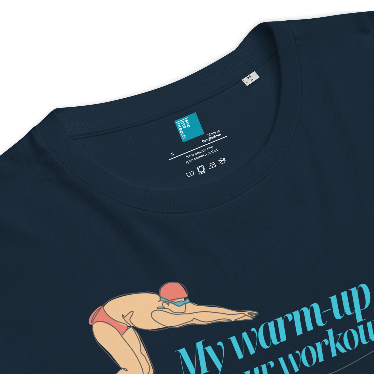 Close-up of organic cotton swim shirt featuring swimmer illustration and 'My warm-up is your workout' text.