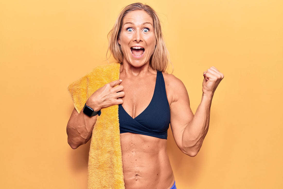 Woman in athletic wear celebrating against a yellow background