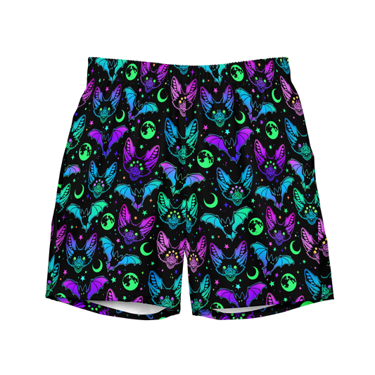 A pair of black Halloween organic swim trunks with a repeating neon pattern of bats, moons, and stars. 