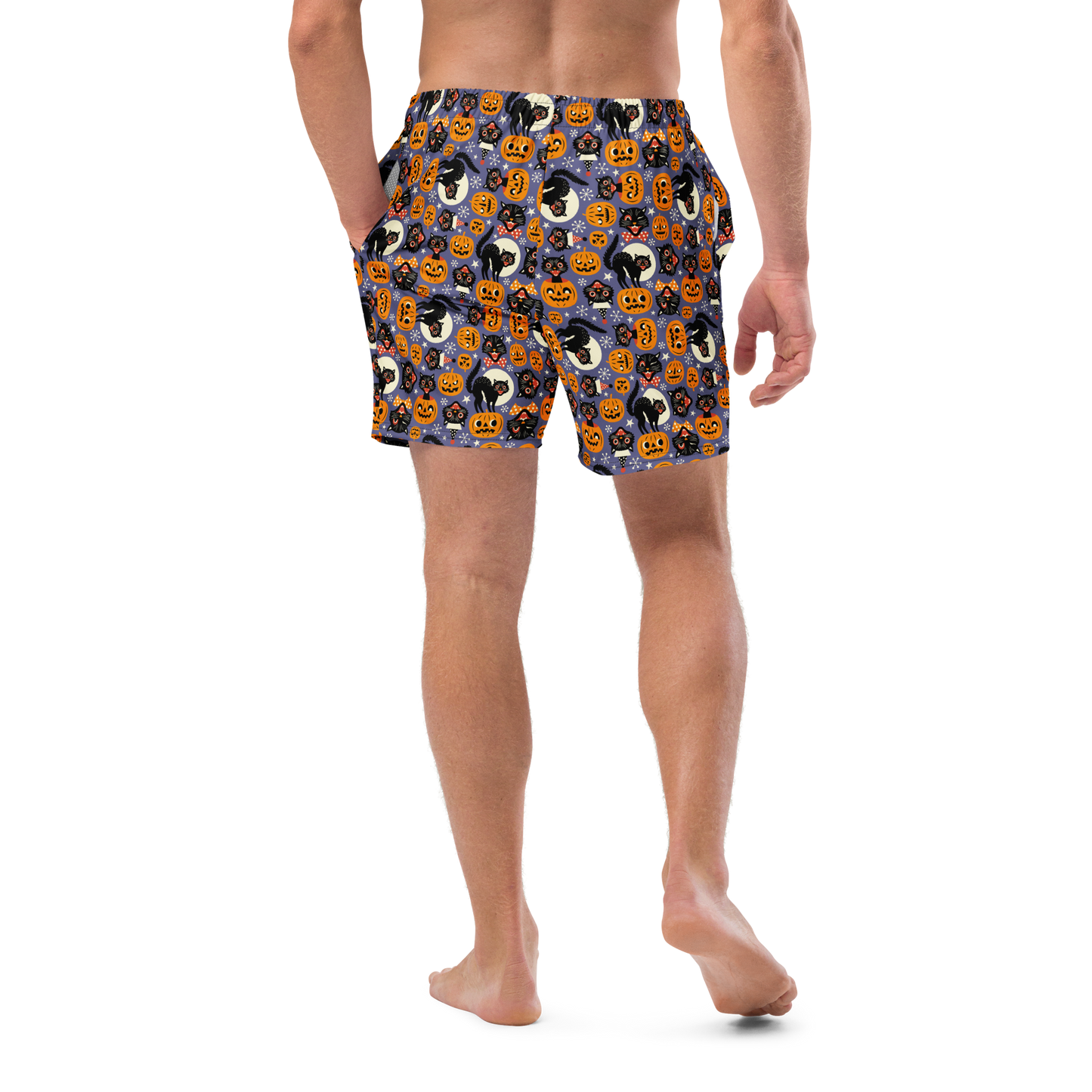 Person wearing Halloween-themed recycled swim trunks on a transparent background