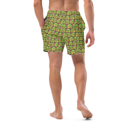 Person wearing green zombie patterned recycled swim trunks on a white background