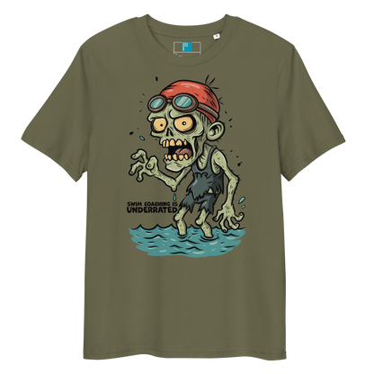 Khaki funny Halloween swimming coach shirt with cartoon zombie coach in red swimming cap and goggles, text reads ‘Swim Coaching is Underrated’