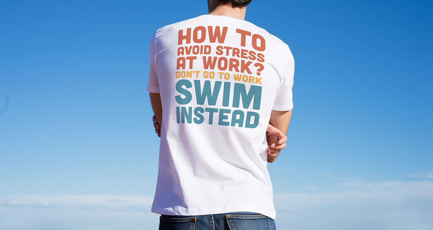 Young man wearing an organic t-shirt with humorous text about avoiding stress at work by swimming, against a clear blue sky.