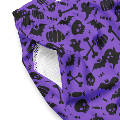 Purple swim trunks with black Halloween patterns on a white background