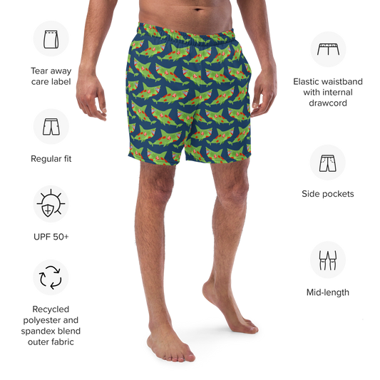 Person wearing shark-patterned Halloween organic swim trunks with product features listed on a white background