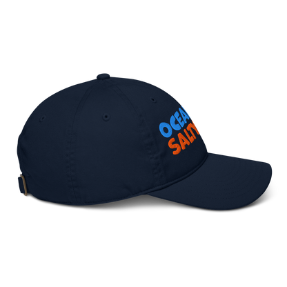 Navy blue baseball cap with 'ocean air, salty hair' text on a white background