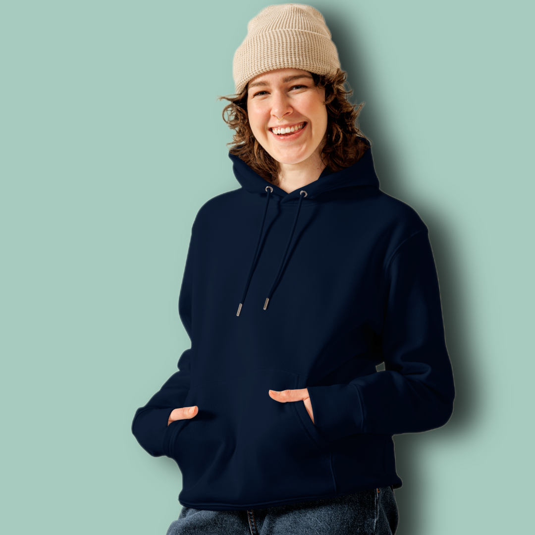 Person wearing a navy organic hoodie and beige beanie against a light green background