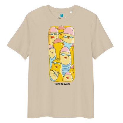 A beige short-sleeve crewneck organic cotton t-shirt featuring a colorful graphic print of cartoon birds in swimwear inside a yellow frame, with the text 'Sink or swim' printed below.