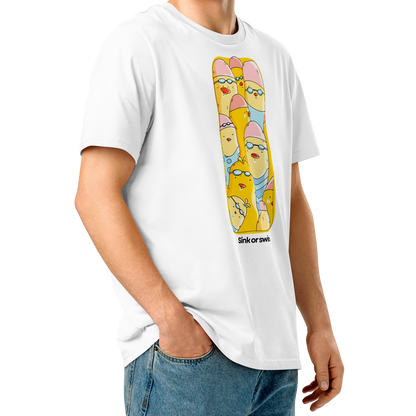A young man with curly brown hair wearing an organic cotton t-shirt white Lane Line Threads tee with colorful Sink or Swim cartoon swimmers in caps and goggles graphic and blue jeans, standing against a solid white background.