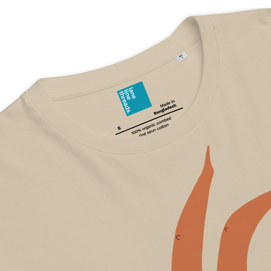 Beige t-shirt with orange design and label on a white background