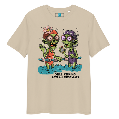 Beige organic cotton Halloween swim practice shirt with cartoon zombie swim besties holding lane line, text reads ‘still kicking after all these years'