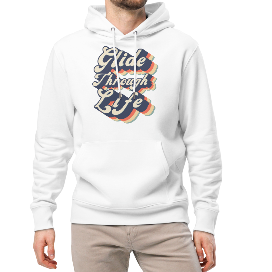 A man modeling an organic hoodie with "Glide Through Life" retro 3D typography on white GOTS and OCS certified cotton, designed for swimmer recovery, paired with beige pants and white sneakers, against a plain white background