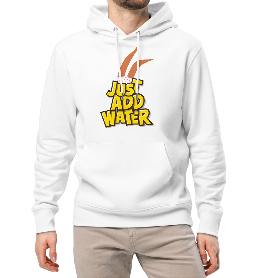 A man modeling an organic hoodie featuring a "Just Add Water" graphic with synchronized swimming legs on white GOTS certified organic cotton, paired with beige pants and white sneakers, against a plain white background.