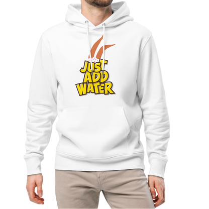 A man modeling an organic hoodie featuring a "Just Add Water" graphic with synchronized swimming legs on white GOTS certified organic cotton, paired with beige pants and white sneakers, against a plain white background.