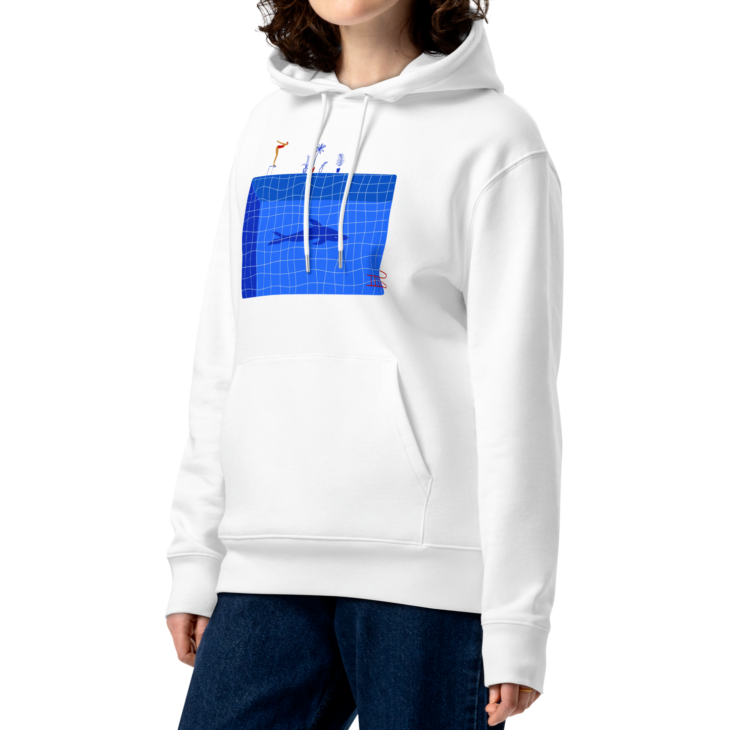 A model with curly brown hair wearing an organic hoodie in white by Lane Line Threads featuring a graphic of a diver, potted plants, and a shark silhouette in a blue pool.