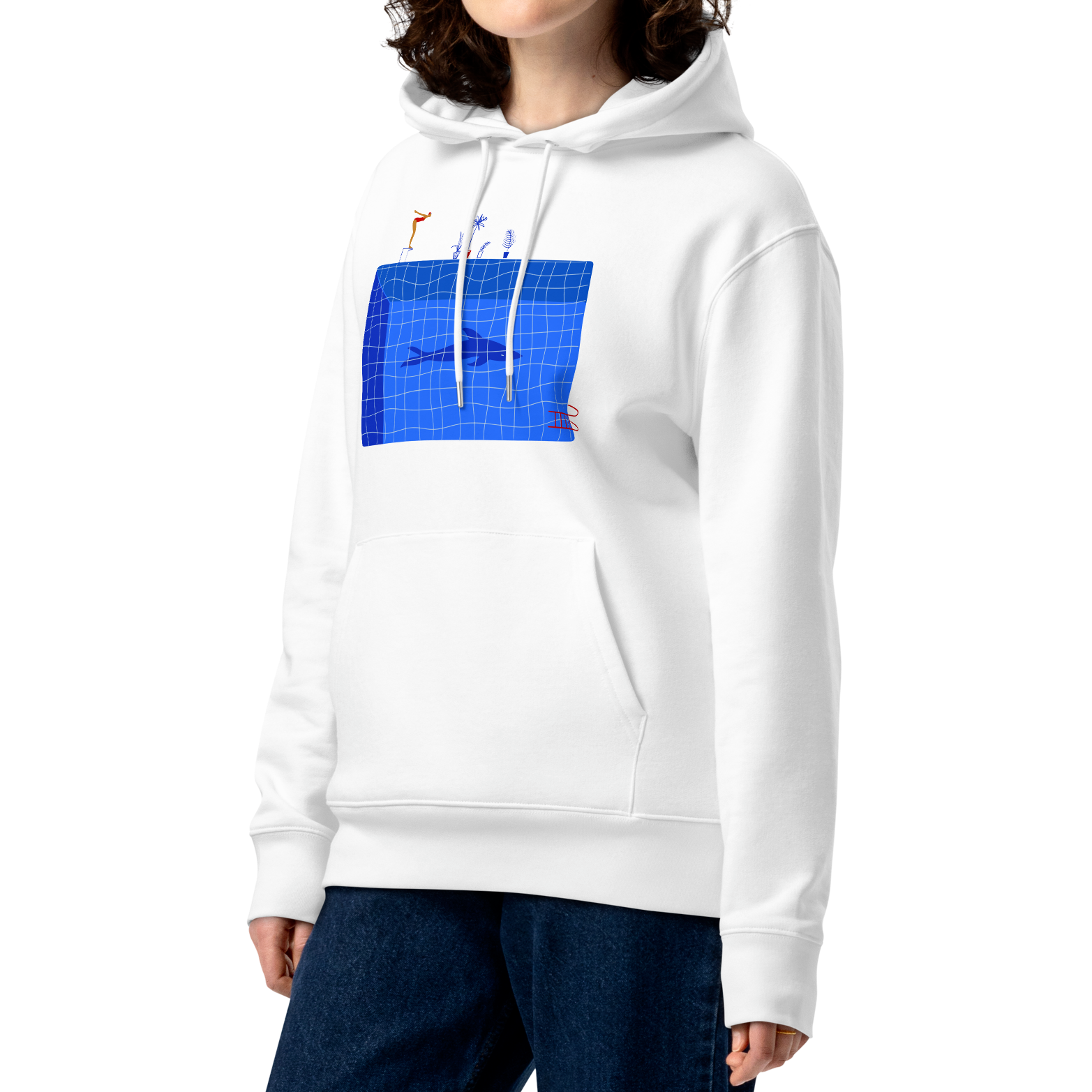 A model with curly brown hair wearing an organic hoodie in white by Lane Line Threads featuring a graphic of a diver, potted plants, and a shark silhouette in a blue pool.