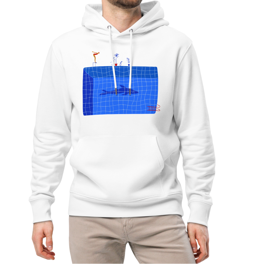 A man modeling an organic hoodie in white by Lane Line Threads featuring a graphic of a diver, potted plants, and a shark silhouette in a blue pool.