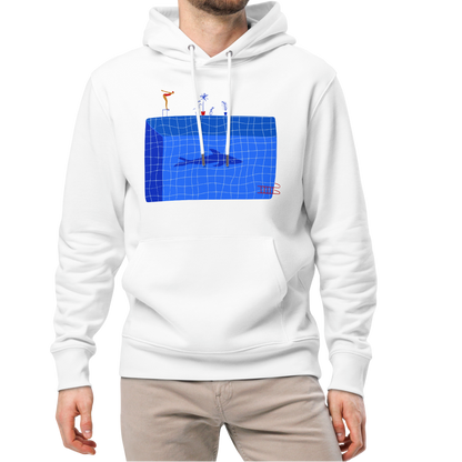 A man modeling an organic hoodie in white by Lane Line Threads featuring a graphic of a diver, potted plants, and a shark silhouette in a blue pool.